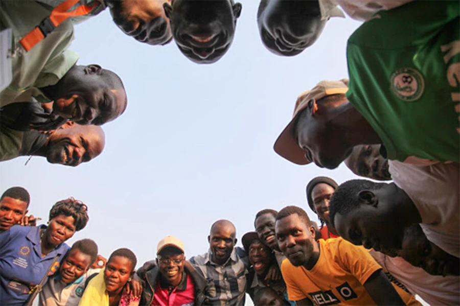 People holding each other's arms in a circle
